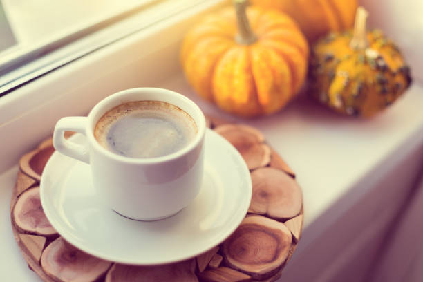 istock Cup of coffee on window sill, cozy autumn 1278239616