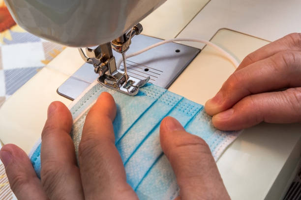 istock a woman sews a protective medical mask for herself 1278241628