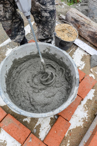 istock a male bricklayer mixes mortar for bricklaying a brick wall 1278241638
