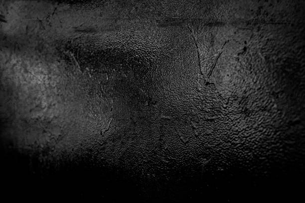 istock Old black and gray metal surface with damaged paint surface covered with scratches, cracks and grain. 1278242684