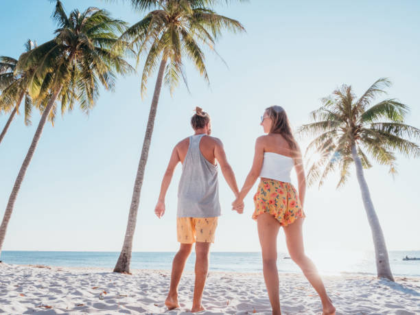 istock Couple holding hands on tropical beach 1278244039