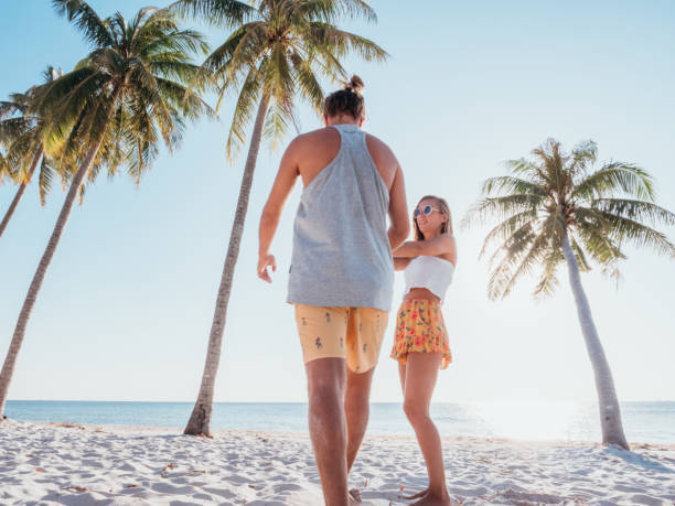 istock Couple holding hands on tropical beach 1278244060