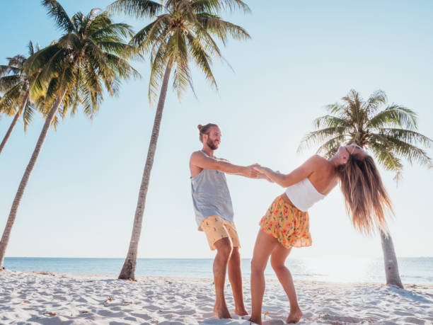 istock Couple holding hands on tropical beach 1278244118