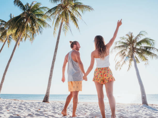 istock Couple holding hands on tropical beach 1278244181