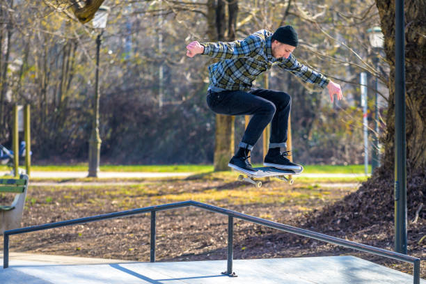istock Skateboarder in mid-air while jumping on a rail 1278245900