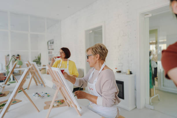 istock Senior woman painting in art class 1278247464