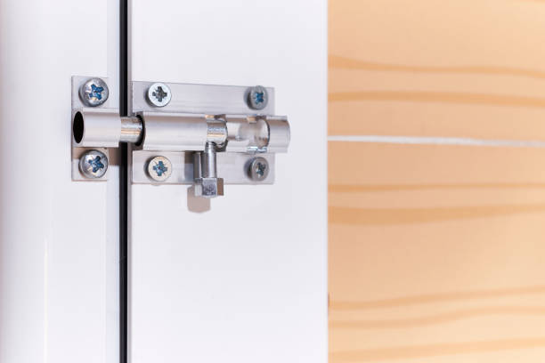 manual latch with metal pin and screws installed in an aluminum carpentry door inside a house Aluminum manual latch bolt installed on a white lacquered aluminum carpentry door inside a home latch photos stock pictures, royalty-free photos & images