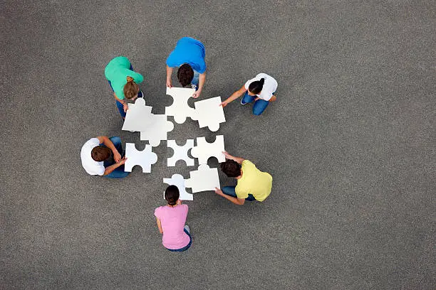 Photo of People putting together jigsaw puzzle