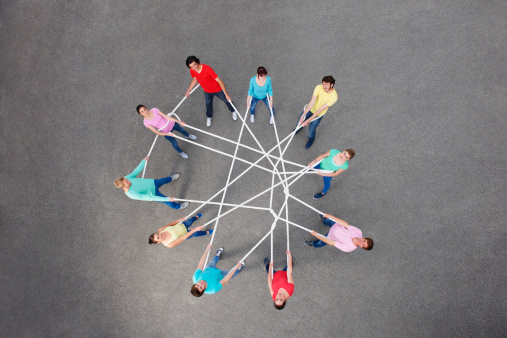 3D illustration of people connecting together puzzle elements. Business teamwork and collaboration, partnership, cooperation and development concept. Multicultural team, unity in diversity.