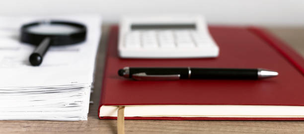 istock Calcilator single Magnifying Glass with Black Handle, Leaning on the financial data. Business and Finance concept. 1278252362