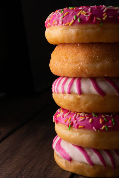 Multicolored donuts on a wooden table