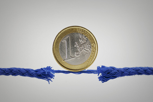 Euro coin on broken rope - Concept of economy and financial risk