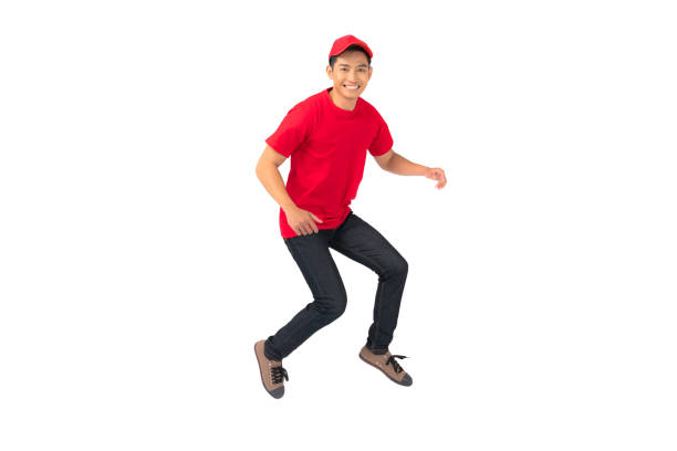 istock Smiling man employee in red cap blank t-shirt uniform jumping 1278254952