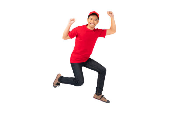 istock Smiling man employee in red cap blank t-shirt uniform jumping 1278254960