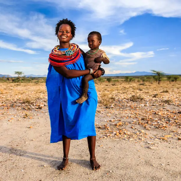 Photo of Young African woman carrying her baby, Kenya, East Africa