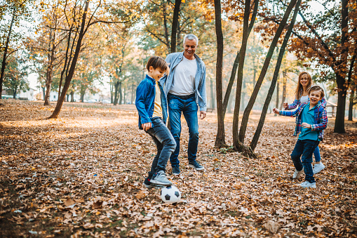 Family playing soccer stock photo