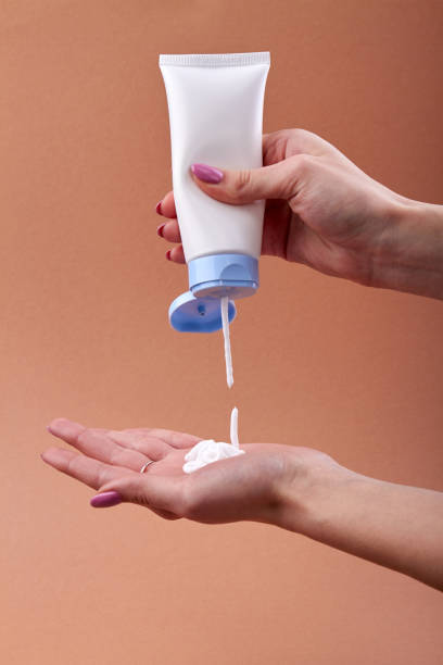 istock Pouring cream from the tube on a hand. 1278260526
