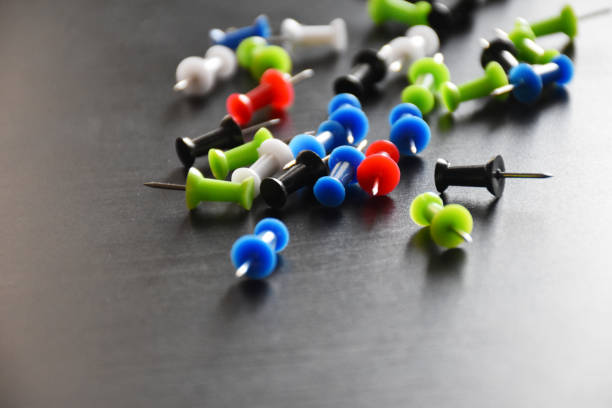 istock colorful punch pins drawing pins on black background 1278263222