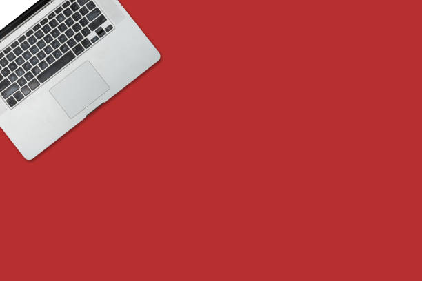 istock Open laptop isolated on red background desk. 1278266211