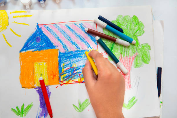 istock High angle close-up image of hands making drawing and filling colors. 1278267669