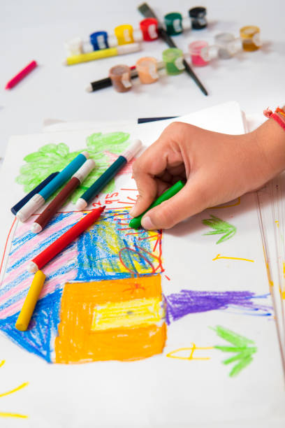 istock High angle close-up image of hands making drawing and filling colors. 1278267673