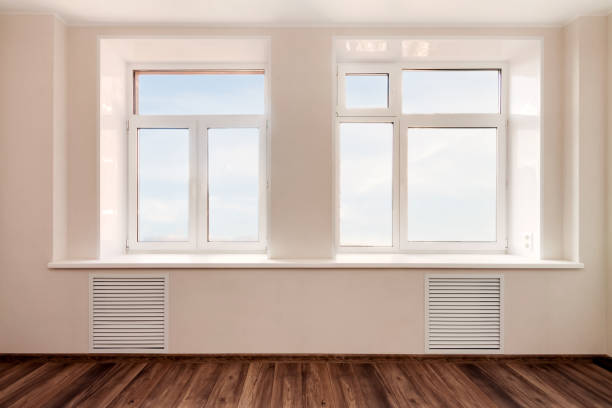 istock White empty room wall with two windows and wooden floor. Loft interior mockup. 3d render home blank space. 1278268519