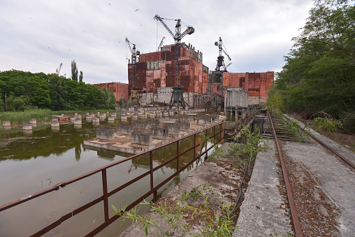 Unfinished unit 5 of Chernobyl nuclear power plant with cranes, summer season, abandoned building in exclusion zone, Ukraine