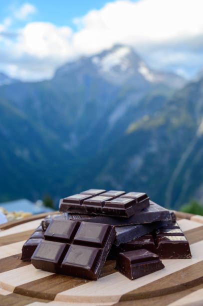 istock Handmade pure dark swiss chocolate and Alpine mountains on background 1278268932
