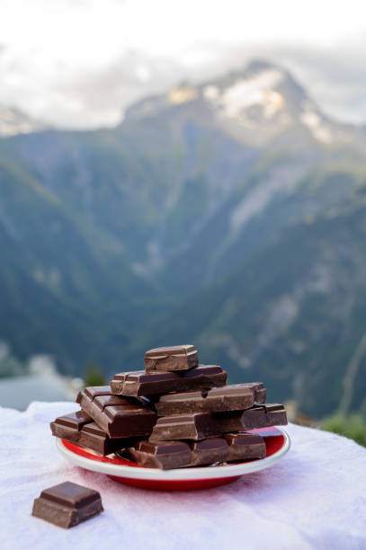 istock Handmade pure dark swiss chocolate and Alpine mountains on background 1278268945