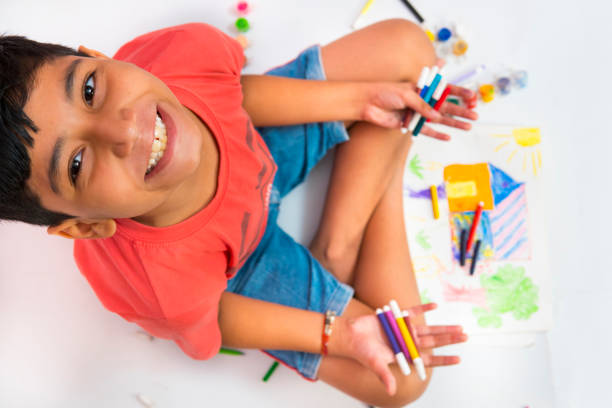 istock Happy boy making colorful house drawing and looking at camera. 1278269007