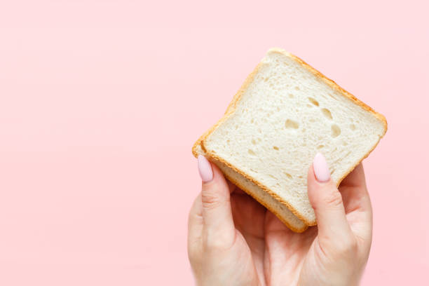 istock hand holding two slices of bread 1278269016
