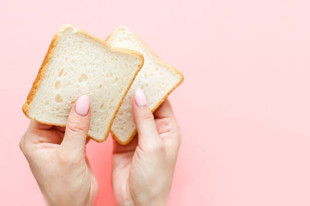 istock hand holding two slices of bread 1278269078