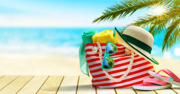 istock Beach bag, flip flops, hat and sunglasses on a tropical beach. 1278269232