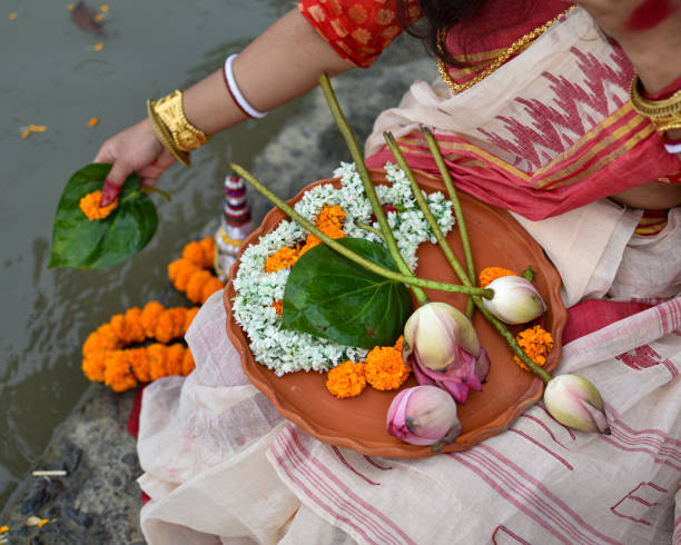 A Women is holding a borondala (Pooja thali for worshipping God) of religious offering. stock photo