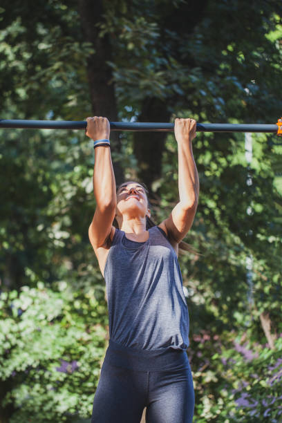 istock Young woman doing chin-ups 1278274231