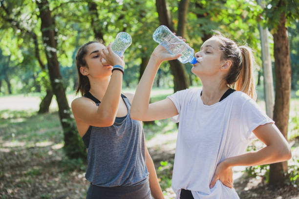 istock Young women drinking water during training in nature 1278274886