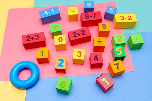 istock child kid colorful education toys cubes with numbers math pattern background on the bright background. Flat lay. Childhood infancy children babies concept. 1278276254
