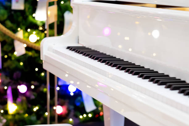 istock Closeup white piano with light on background 1278276470