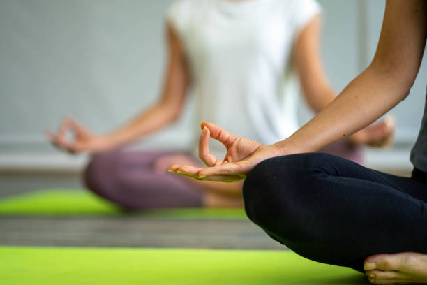 istock caucasian woman doing yoga exercise workout on yoga mat with  instructor  teaching and pose adjusting 1278279610
