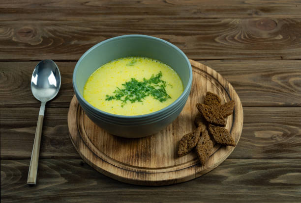 istock Appetizing cheese soup in a gray plate on a wooden background. 1278285843