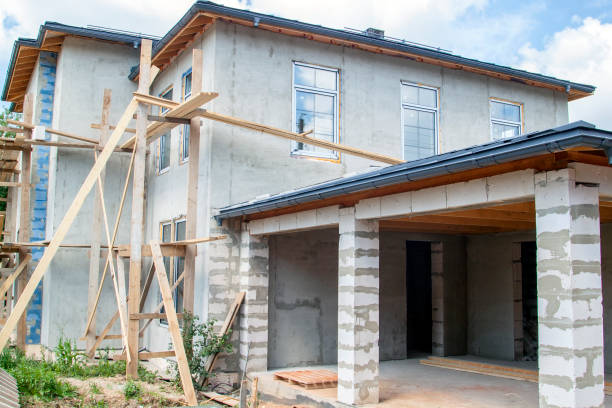 istock facade of cottage under construction covered with plaster with new windows inserted 1278286898