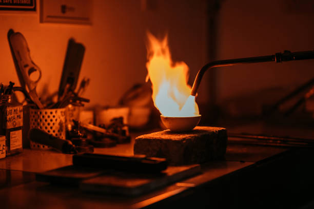 istock Goldsmith melting and casting with blow torch at college workbench 1278288396