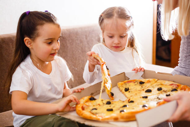 istock Young girls eating pizza 1278289760