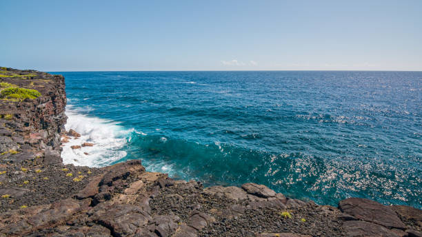 istock Cliffs on the seashore. Large boulder among the waves in the sea. Hawaii 1278292308