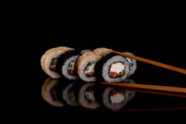 istock Fresh delicious beautiful sushi rolls on a dark background 1278293179