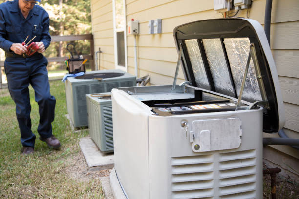 Technician services outside AC units and generator. stock photo