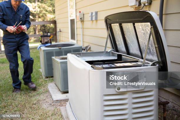 Technician Services Outside Ac Units And Generator Stock Photo - Download Image Now