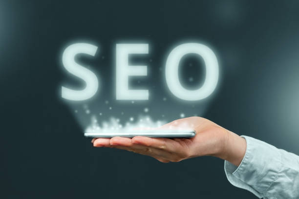 Search engine optimization concept over smartphone in hand of businessman.