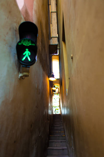 The architecture of the strago city of Prague. The narrowest street in Europe. The passage between buildings for one person, regulated by traffic lights The architecture of the strago city of Prague. The narrowest street in Europe. The passage between buildings for one person, regulated by traffic lights. narrow streets stock pictures, royalty-free photos & images