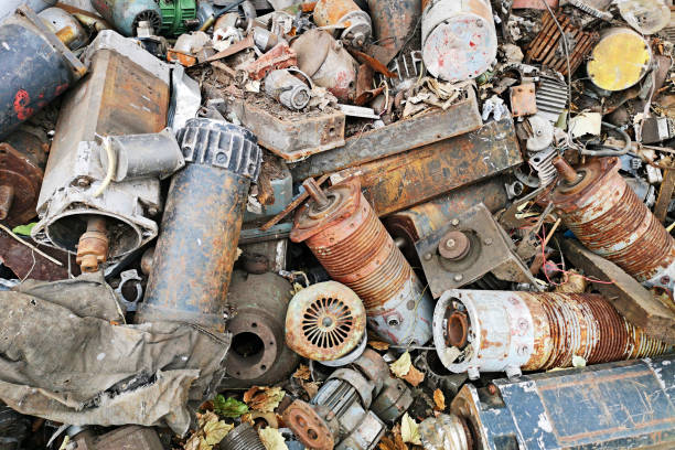 istock Rusty engines stacked in the scrapyard. Engine parts greased and covered with rust. Dump of pieces of iron and wrecking machinery parts. Scrap yard for recycle the old engine, engine junkyard 1278302841